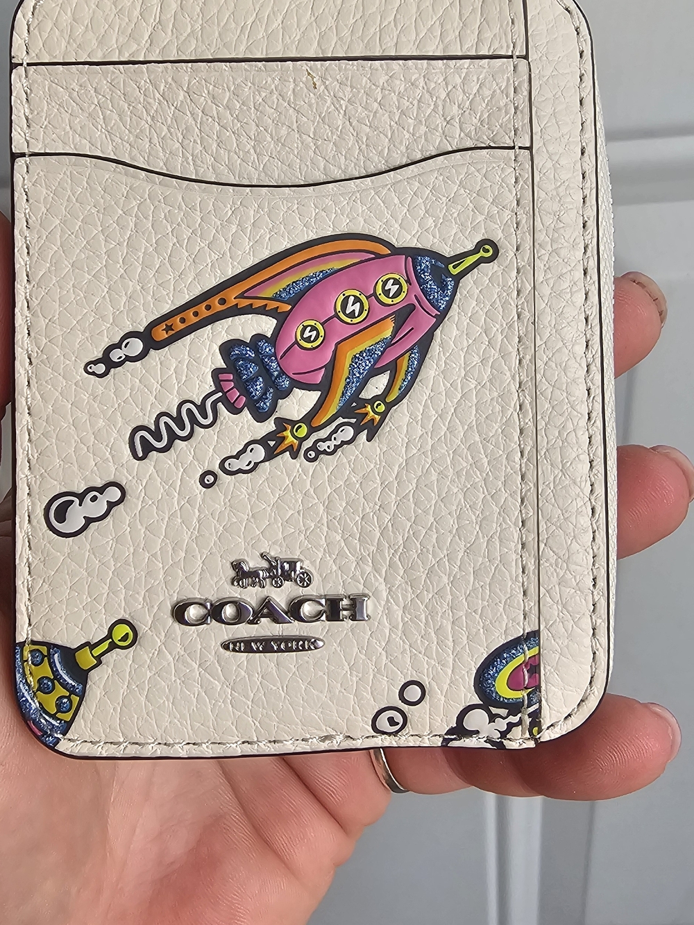 COACH Cream Pebbled Leather Card Holder with Colorful Rocket Motif